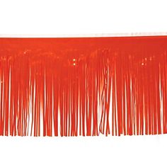 an orange curtain with fringes hanging from it