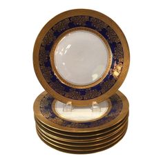 a stack of gold and blue plates sitting on top of each other