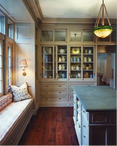 a large kitchen with wooden floors and cabinets