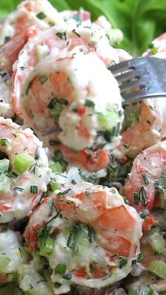 a close up of a salad with shrimp and broccoli