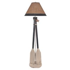 a lamp with two paddles on it and a shade over the base that is made from wood