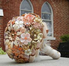 a bridal bouquet sitting on the ground in front of a brick building