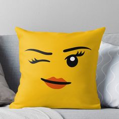 a yellow pillow with a face drawn on it