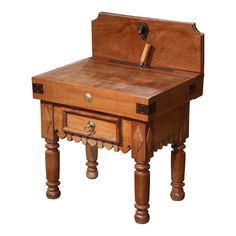 an old wooden desk with a hammer sticking out of it's center drawer and legs