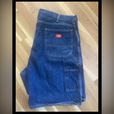 **These Are Nwot** The Product Is A Pair Of Dickies Carpenter Jean Shorts For Men In Size 40 And Blue Denim Color. The Shorts Have A Solid Pattern, Flat Front, And A 5-Pocket Design. They Feature A Zip Closure, Button And Zipper Accents, And A Logo. The Fabric Is 100% Cotton Denim With A Medium Wash. The Shorts Are Machine Washable And Have A Regular Fit. They Are Suitable For Casual And Workwear Occasions, And Have A Carpenter Style. The Shorts Have A 9 Inch Inseam And Are Designed For Summer, Carpenter Shorts Outfit, Men’s Jean Shorts, Carpenter Shorts, Dickies Cargo Pants, Dickie Work Pants, Dickie Jeans, Long Jean Shorts, Dickies Shorts, Mens Jean Shorts