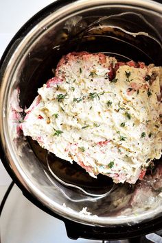 a crock pot filled with food sitting on top of a stove