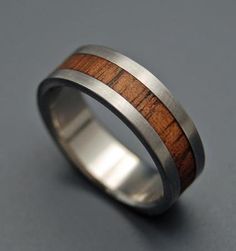 a wedding ring made out of wood and stainless steel