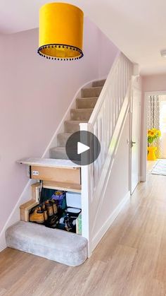 the stairs in this house have been painted pink and white with yellow lamps hanging from them