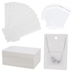 the package includes several pieces of white paper, two necklaces and one card holder