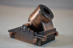 an old metal object sitting on top of a table