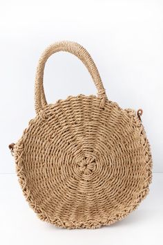 Take in the scenery with the Bayview Tan Round Woven Purse! This on-trend woven straw purse features a structured, round design, and roomy, zippered interior with sidewall pocket. Carry by the twin tote handles with 4" drop, or attach the 48" adjustable strap. Nice Purses, Woven Purse, Straw Purse, Best Caps, Best Purses, Cute Handbags, Round Design, Decorative Wicker Basket, Straw Bag