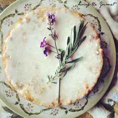 a cake with flowers on it sitting on a plate