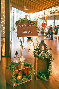 a wooden sign with greenery on it that says welcome to the newly married couple