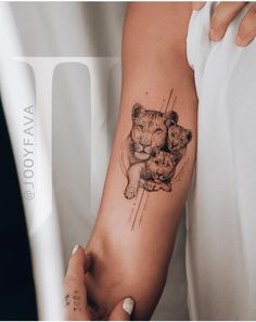 a woman with a lion tattoo on her arm