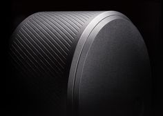 a close up view of the front end of a speaker in black and grey tones