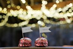 two candy apples sitting on top of a table