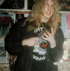 a man with long hair is holding a book