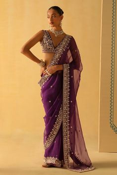 Deep purple saree with floral dabka zardosi embroidery. Paired with a raw silk embroidered blouse with a deep V neck in the front and back. - Aza Fashions Purple Chanderi Pre-draped Saree For Reception, Traditional Sleeveless Pre-draped Saree For Eid, Purple Tissue Silk Pre-draped Saree For Reception, Traditional Sleeveless Pre-draped Saree With Pallu, Festive Saree With Dupatta, Festive Sleeveless Saree With Dupatta, Purple Pre-draped Saree With Dori Work, Traditional Sleeveless Chanderi Pre-draped Saree, Traditional Sleeveless Saree For Reception