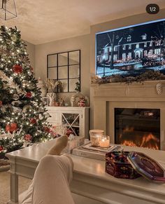 a person sitting in front of a christmas tree watching tv