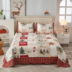 a bed with a christmas themed comforter and pillows