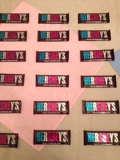 hershey's candy bar wrappers are laid out on a pink tablecloth