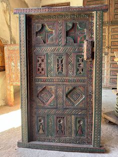 an old wooden door with decorative designs on it