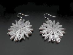 Are you looking for a special gift for someone or yourself? This is exactly what you are looking for. These beautiful hand crafted earrings are made from 1/8" thick quilling paper strip in silver edge ivory color. They are attached to hypo-allergenic silver plated earring hooks.  The earrings are coated with clear acrylic sealant to provide sturdiness to the jewelry. But it is not 100% water-proof. Please remove jewelry prior to swimming, bathing, or other water-based activities. In case of water contact, gently dab with a paper towel and allow to dry completely.  Please message me for custom order requests or questions. The rest of my collection is available at  https://breezechicdesigns.etsy.com Snow Flakes Paper, Paper Quilling Jewelry Set, Quilling Earrings Unique, Earrings Quilling, Quilled Stud Earrings, Quilling Studs Earrings, Paper Quilling Stud Earrings, Paper Quilling Earrings, Crafted Earrings