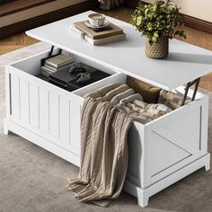 a white coffee table with an open drawer underneath it and a blanket on the floor