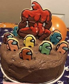 a chocolate cake with icing and decorations on it sitting on top of a table