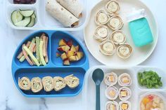 a table topped with plates filled with food and veggies next to utensils