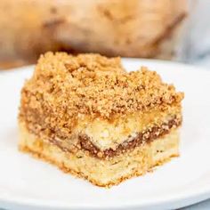 a close up of a piece of cake on a plate with another slice in the background