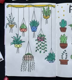 an open notebook with potted plants hanging from it