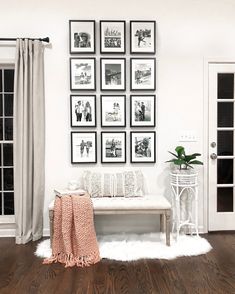 a room with pictures hanging on the wall and a bench in front of some doors