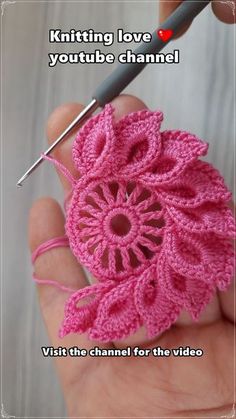 someone is crocheting a pink flower with a video in front of them that says, knitting love you tube channel visit the channel for the video