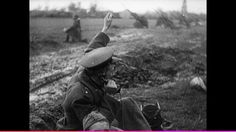 an old black and white photo of two men in the middle of a field pointing at something