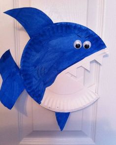 a paper plate shaped like a blue dolphin