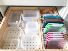 an open drawer filled with lots of plastic containers