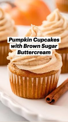 pumpkin cupcakes with brown sugar buttercream on a white plate next to cinnamon sticks