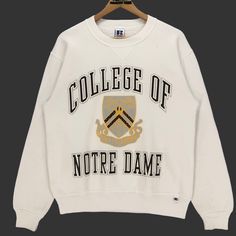 Vintage 90s College Of Notre Dame crewneck sweatshirt in white colour. Big logo printed on the front. Still in good condition. SEE THE PICTURES FOR MORE DETAILS. CONDITION : 9/10 MEASUREMENT Pit : 21 inch Length : 25 inch Shoulder : 20 inch Arm Length : 24 inch Size On Tag : M Recommended Size : S-M PAYMENT We accept PayPal only. The item will be ship 3-5 days once the payment has been made. SHIPPING DHL ONLY. USUALLY AROUND 7-21 DAYS BEFORE REACH THE DESTINATION. *NOTES TO BUYERS* PLEASE DO NOT White Long Sleeve College Sweatshirt, White Long Sleeve Sweatshirt For College, White Collegiate Sweatshirt For Fall, White College Sweatshirt For Fall, White Fall College Sweatshirt, White Sweatshirt With Ribbed Cuffs For Campus, White College Style Tops With Ribbed Cuffs, White Crew Sweatshirt For Campus, Winter Campus White Sweatshirt