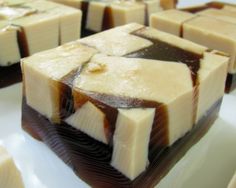 several pieces of cake sitting on top of a white plate covered in chocolate and caramel