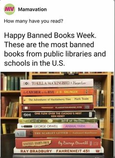 a stack of books sitting on top of a table next to a book shelf filled with books