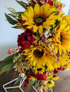 a bouquet of sunflowers and other flowers on a table