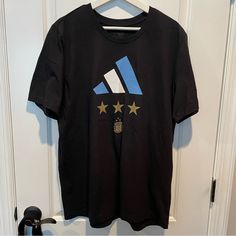 Brand: Adidas Size: L, 22 Pit To Pit Color: Black Condition: Never Worn. If Interested Please Send Offers Casual Adidas Tops For Fans, Casual Adidas Tops For Fan Merchandise, Adidas Crew Neck Top, Black Cotton Top With Star Logo, Adidas Letter Print Crew Neck T-shirt, Casual Black T-shirt With Star Logo, Adidas Black T-shirt With Logo, Adidas Short Sleeve T-shirt With Graphic Print, Black Adidas T-shirt With Logo