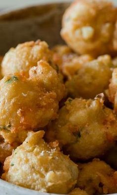 a bowl filled with fried food sitting on top of a table