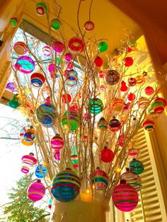 a vase filled with lots of colorful ornaments