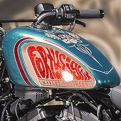 a close up of a motorcycle with graffiti on it