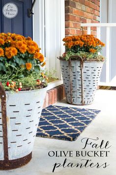 two buckets filled with flowers on the front porch