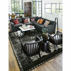 a living room filled with furniture and lots of windows