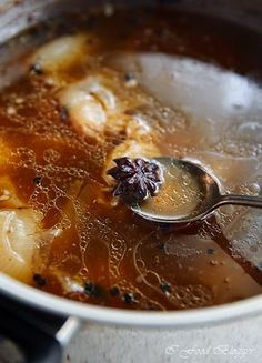 a spoon in a pot filled with soup