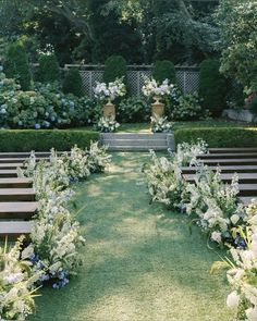 an outdoor ceremony setup with benches and flowers